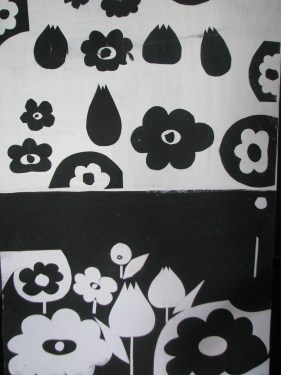 Obraz czarno biały pod tytułem "Optymizm". Górna połowa obrazu to różne czarne kwiaty na białym tle. Dolna połowa to białe kwiaty na czarnym tle.