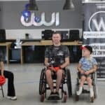 Zespół trzyosobowy na wózkach inwalidzkich z Fundacji Wojownicy z Krakowa, promujący boks dla osób niepełnosprawnych