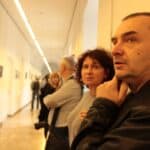 Dużo ludzi obu płci w Wirydarzu Centrum Kultury w Lublinie, oglądających rozwieszone na ścianie po lewej stronie korytarza zwycięskie fotografie 13. Międzynarodowego Konkursu Fotograficznego „Teatr w Obiektywie”, na pierwszym planie od prawej Pan Robert Pranagal
