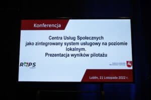 Ekran powitalny z napisem „Konferencja Centra Usług Społecznych jako zintegrowany system usługowy na poziomie lokalnym. Prezentacja wyników pilotażu. Lublin, 21 listopada 2022 r.”