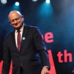 Na scenie stoi uśmiechnięty Prezydent Miasta Lublin - Pan dr Krzysztof Żuk