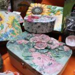 Szkatułki wykonane techniką decoupage na stoisku Stowarzyszenia na rzecz Osób Potrzebujących Wsparcia IUVO