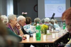 Siedzący przy stole Członkowie Stowarzyszenia podczas cyklicznego zebrania