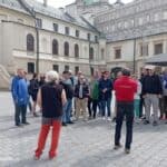 Uczestnicy wycieczki z przewodnikiem na dziedzińcu zamku