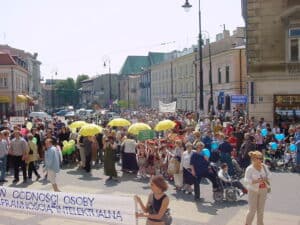 Barwny tłum osób zgromadzonych na głównej ulicy Lublina podczas obchodów Dnia Godności Osoby z Niepełnosprawnością Intelektualną