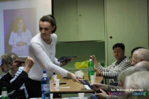 Pani Marta Pomianowska rozdaje vouchery uczestnikom spotkania
