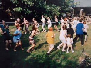 I Międzynarodowe Warsztaty Teatralne dla Instruktorów, Skrzynice 2001. Integracja na świeżym powietrzu, grupa osób porusza się w kręgu